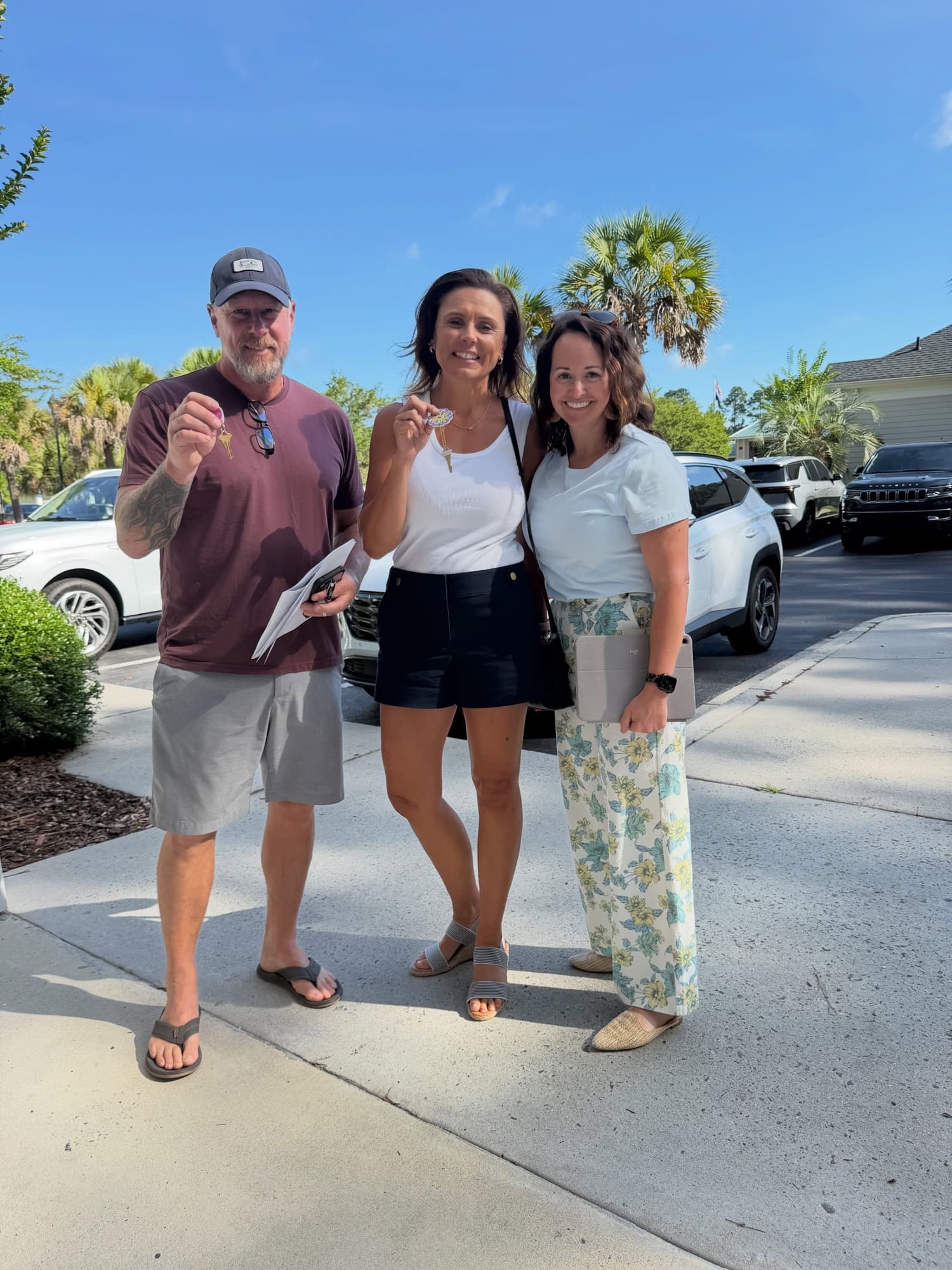 Andrea celebrating closing day with happy first-time buyers holding their new keys
