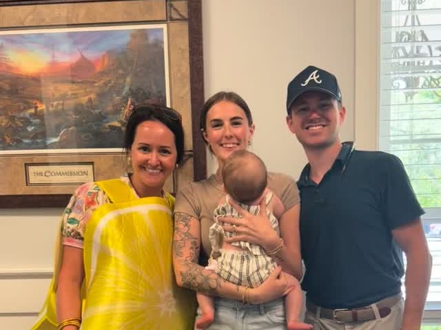 Andrea dressed as a lemon spreading sunshine to a first-time-buyer family and their baby