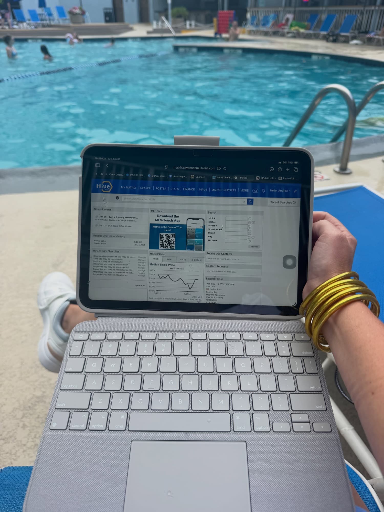 Andrea working from her laptop poolside in Hilton Head, always on the clock for clients